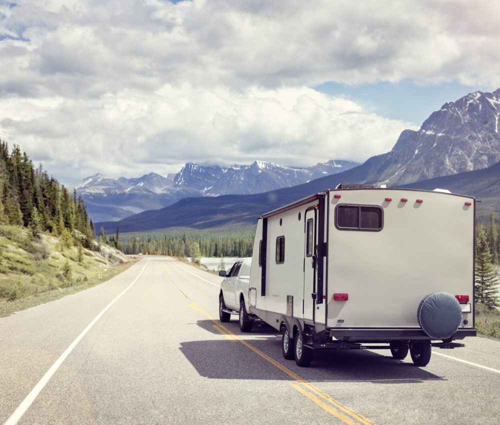 Caravan or recreational vehicle motor home trailer on a mountain road in Canada